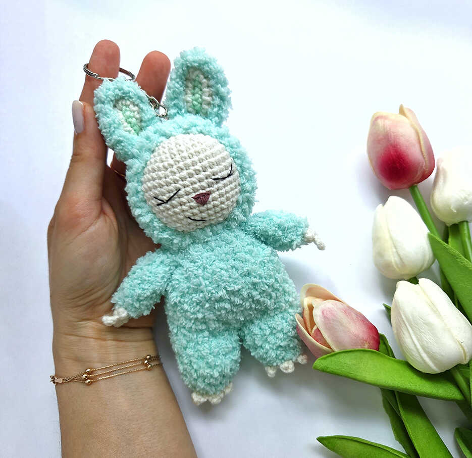 Bunny amigurumi shown in hand as a small plush keychain with soft texture and cute handmade proportions
