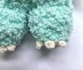 Leg detail of a plush bunny amigurumi highlighting soft texture, rounded shape and neat handmade stitches
