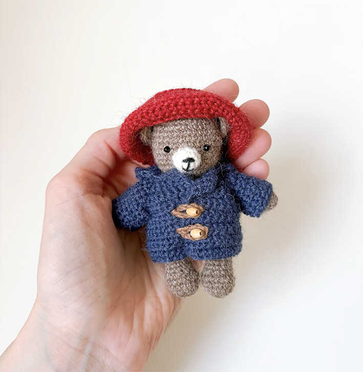 This is a high-quality image of a teddy bear in a Paddington style outfit from our free crochet pattern.