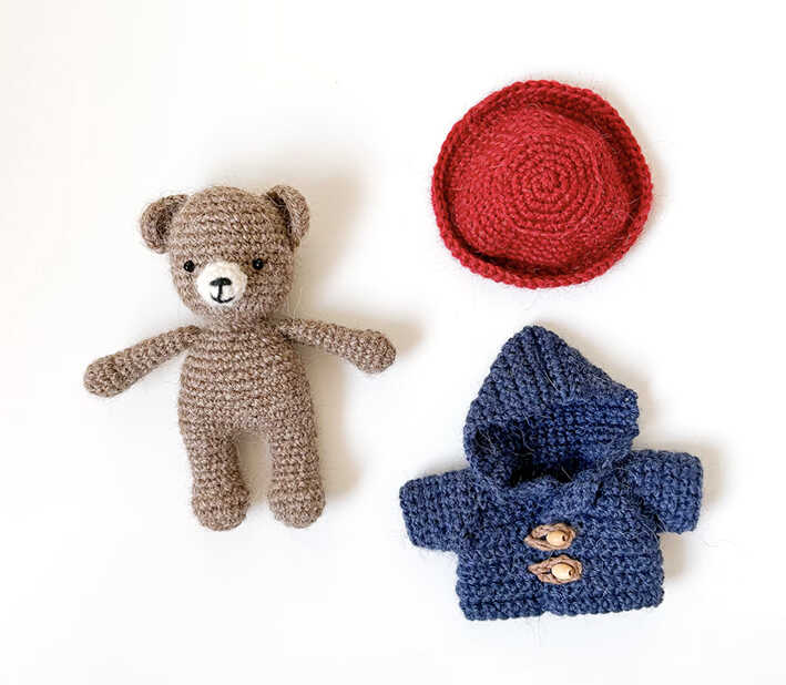 This is a clear image of the DIY crochet bear clothing set from our free pattern instructions.