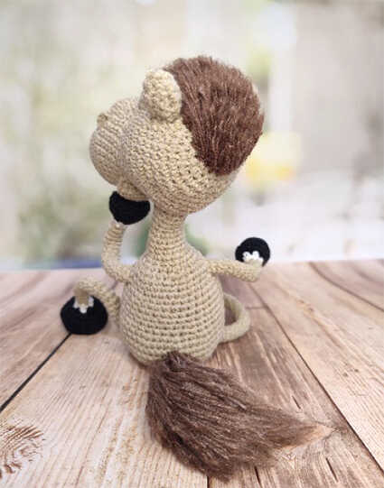 Free Crochet Project: A charming white amigurumi horse ready for nursery decor displays. Create this elegant toy easily using our comprehensive and free pattern instructions.