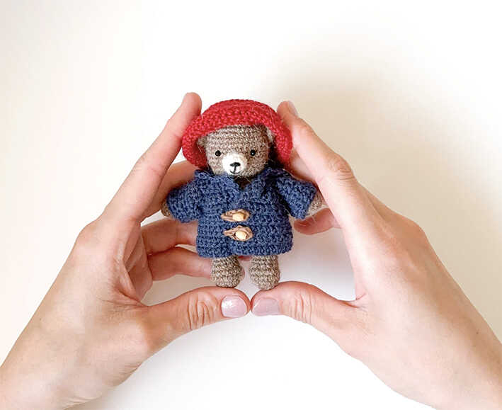 This is a detailed image of the handmade bear doll with its custom outfit from our free amigurumi pattern.