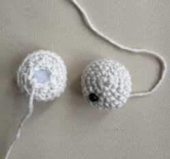 A detailed view of the actual crocheted eyes that are a central part of this free monster pattern. The contrasting yarn colors bring the character's expression to life. You can follow our guide to crochet these eyes exactly as shown here.