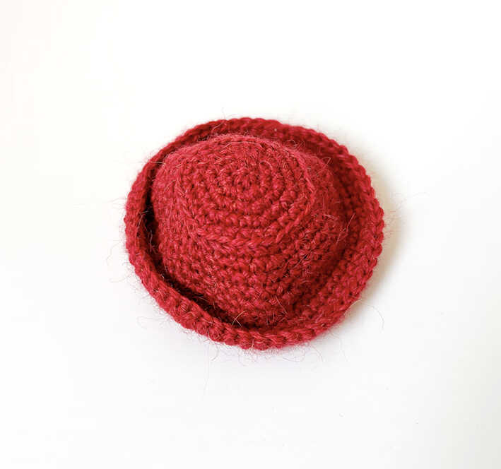 This is a high-quality image of the crochet hat for the bear doll from our free pattern.
