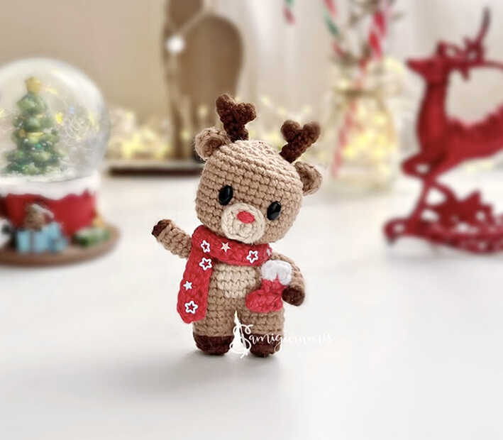 A professional visualization of the Mini Reindeer Rudy, serving as an artistic preview of our free crochet pattern. This image captures the charming character design to provide a stylistic reference for your handmade project. We share this concept to help you visualize the finished amigurumi reindeer.
