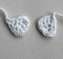 These white crochet pieces are the actual teeth details included in the free amigurumi monster pattern. They are specifically shaped to be attached to the mouth area for a quirky look. The full assembly guide for these parts is in the link.