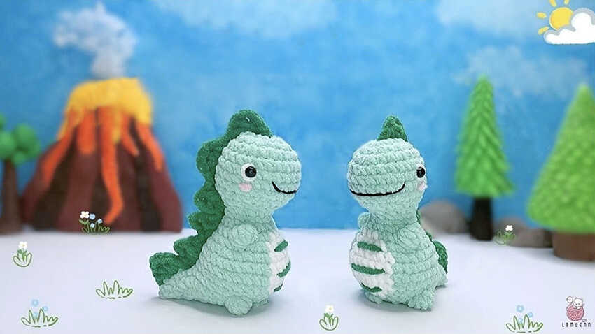 Two no sew dinosaur amigurumi toys displayed in a playful handmade scene with soft yarn texture and cute character style
