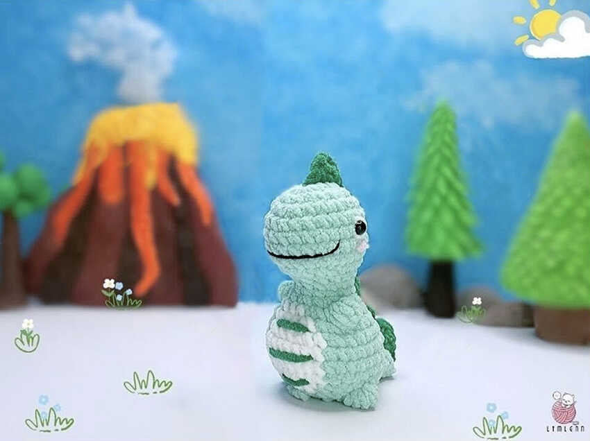 Side view of a no sew dinosaur amigurumi showing body shape, stitch consistency and plush handmade finish